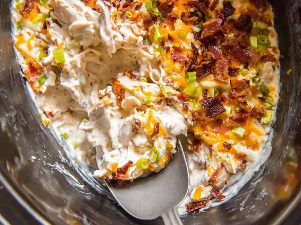 Creamy crack chicken with cheese, bacon, and ranch, in a Crockpot.