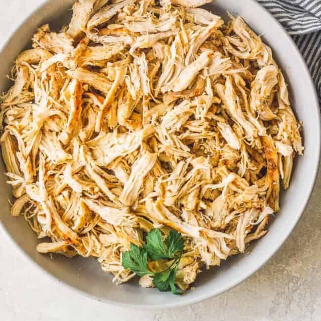 shredded chicken in white bowl