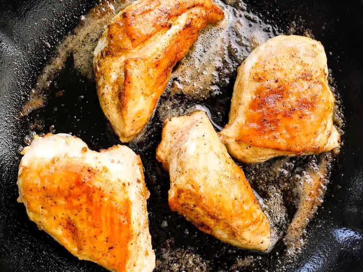 seared chicken breast in cast iron skillet.