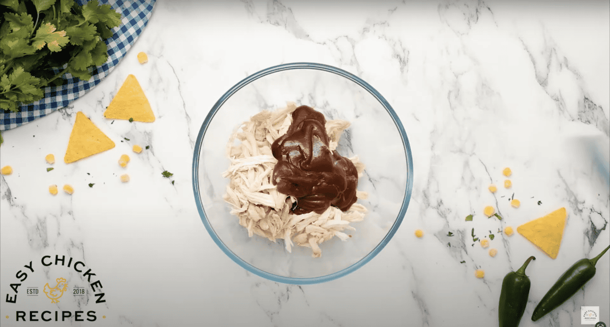 Rotisserie chicken and bbq sauce in a glass bowl.