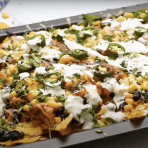 A tray of baked bbq chicken nachos.