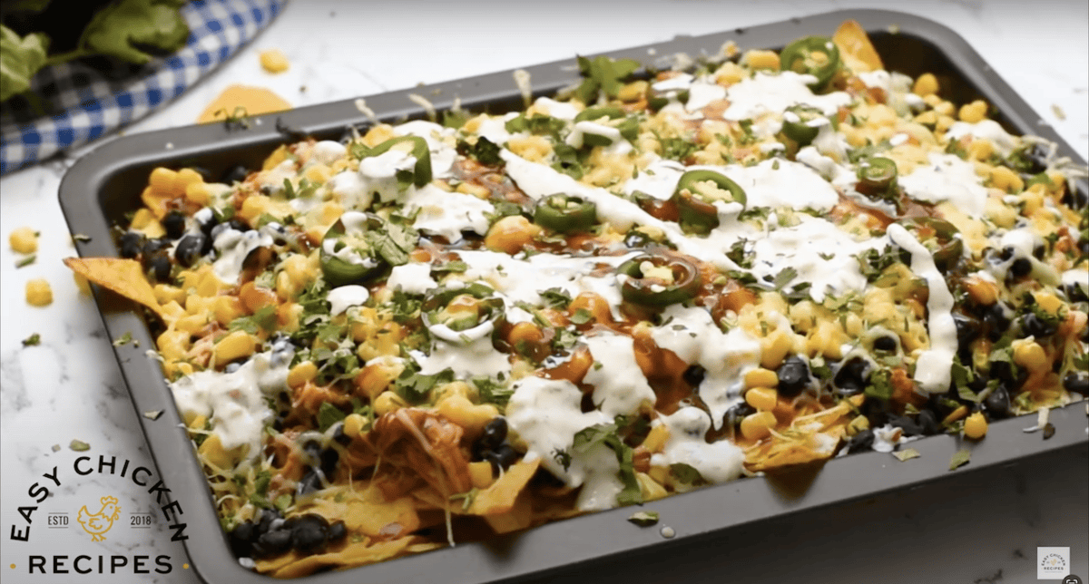 A tray of baked bbq chicken nachos.