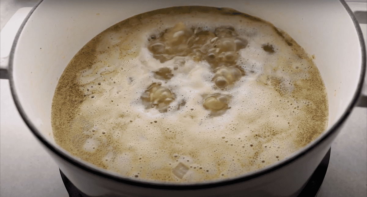 Chicken broth boiling in a pot.