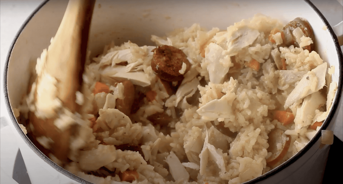 Stirring rotisserie chicken into the chicken bog.