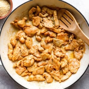 cooking chicken pieces in a pan.