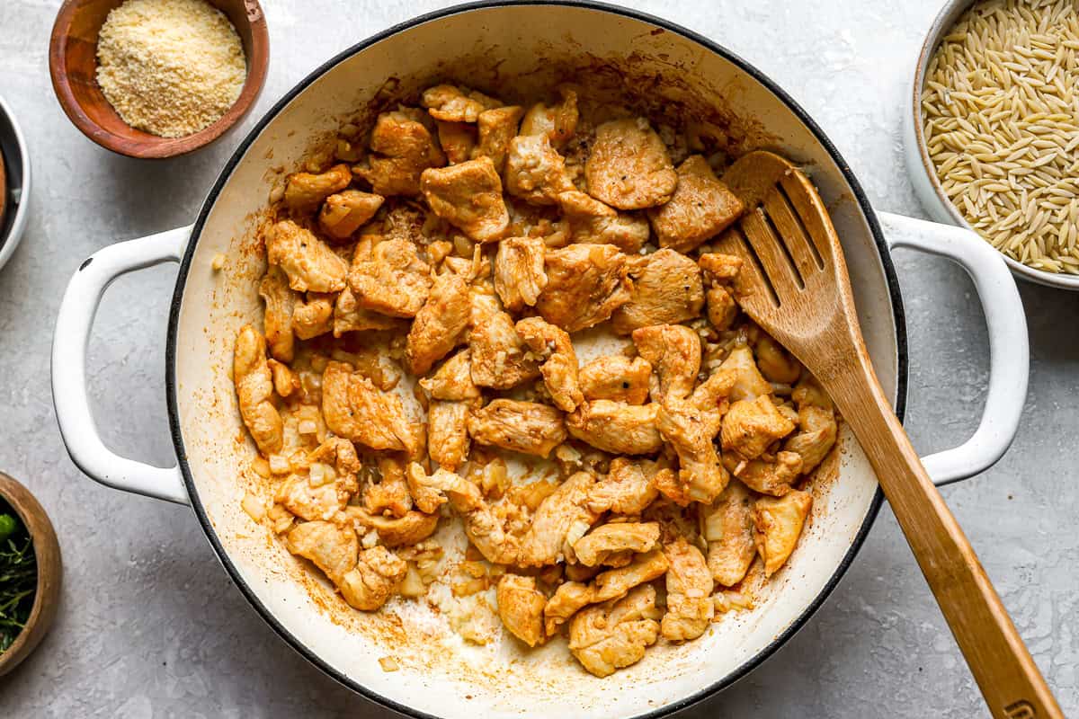 cooked chicken and onions in a pan.