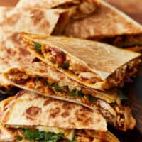 side view of bbq chicken quesadillas cut into wedges.