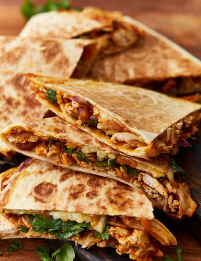 side view of bbq chicken quesadillas cut into wedges.