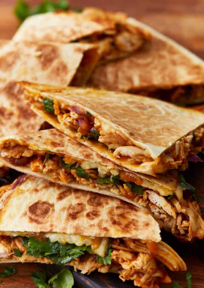 side view of bbq chicken quesadillas cut into wedges.