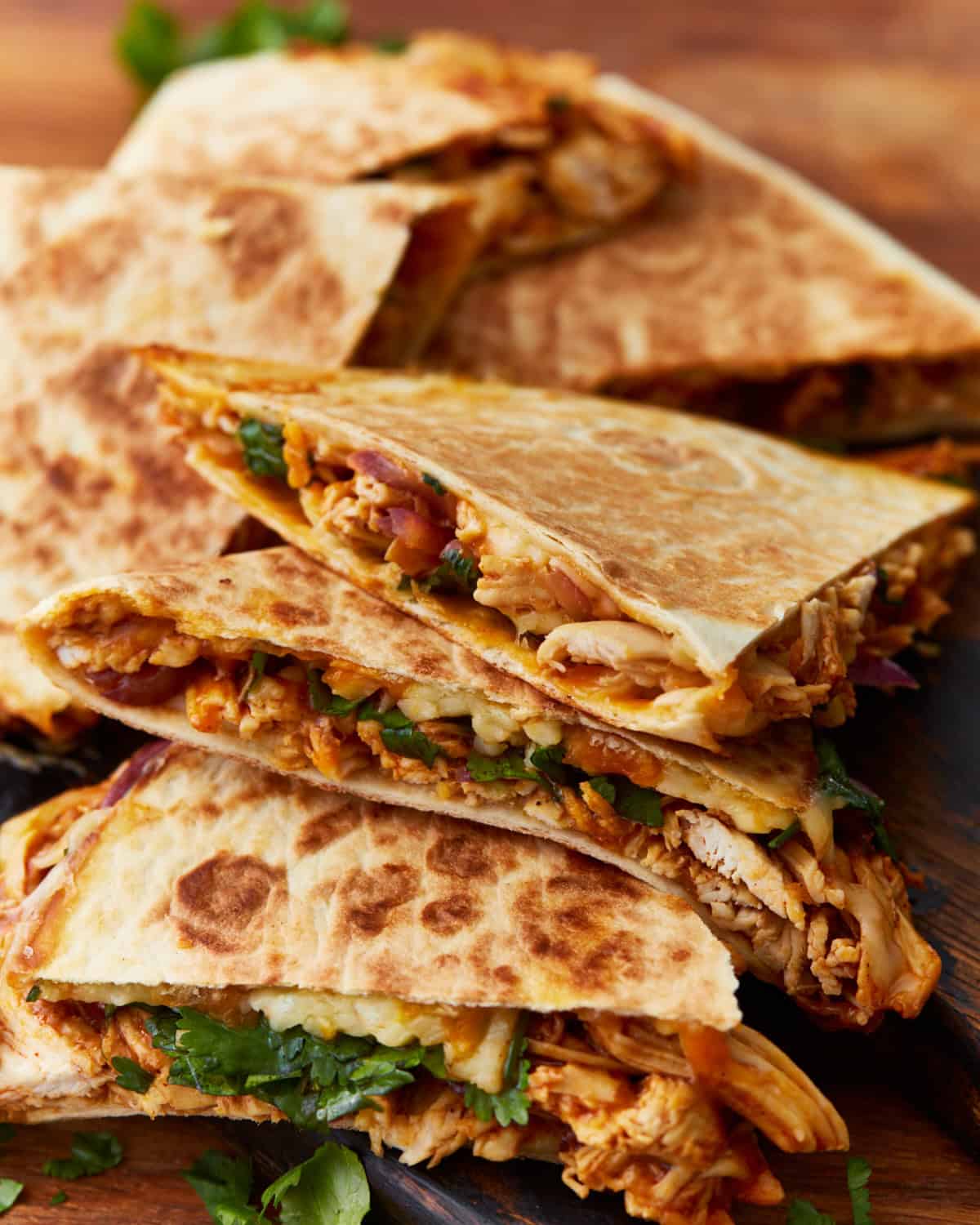 side view of bbq chicken quesadillas cut into wedges.