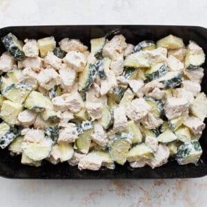 chicken zucchini casserole filling in a baking dish.