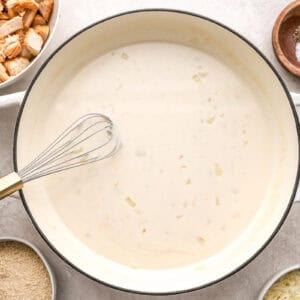 Whisking cream mixture in a pot.