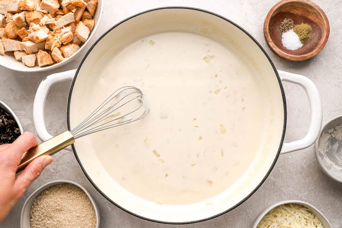 Whisking cream mixture in a pot.