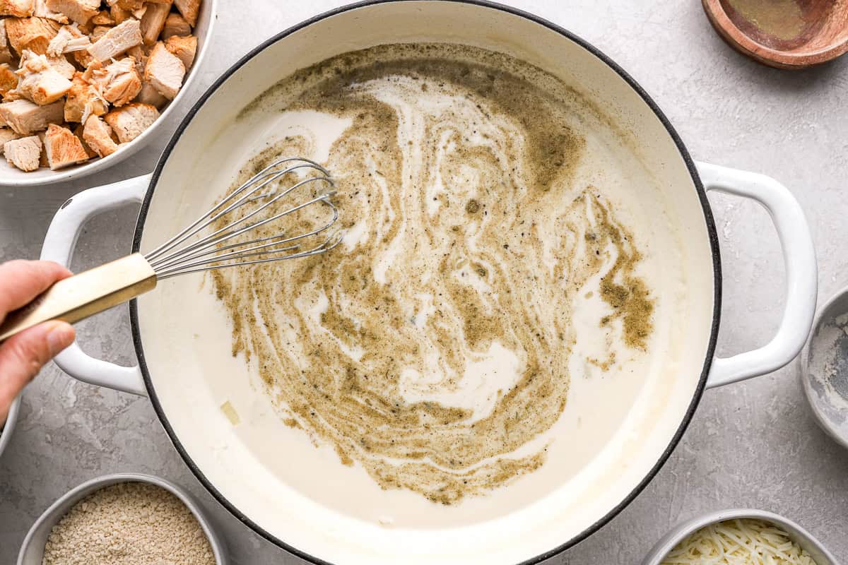 Whisking ingredients together in a pot.