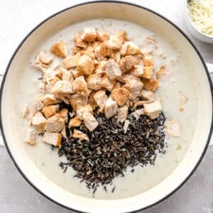 Pieces of of chicken and wild rice piled in a cream soup base.