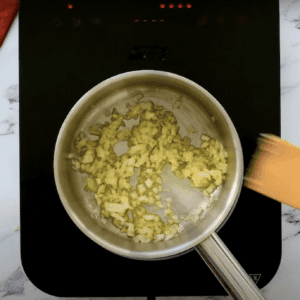 Cooking onions and garlic in a saucepan.