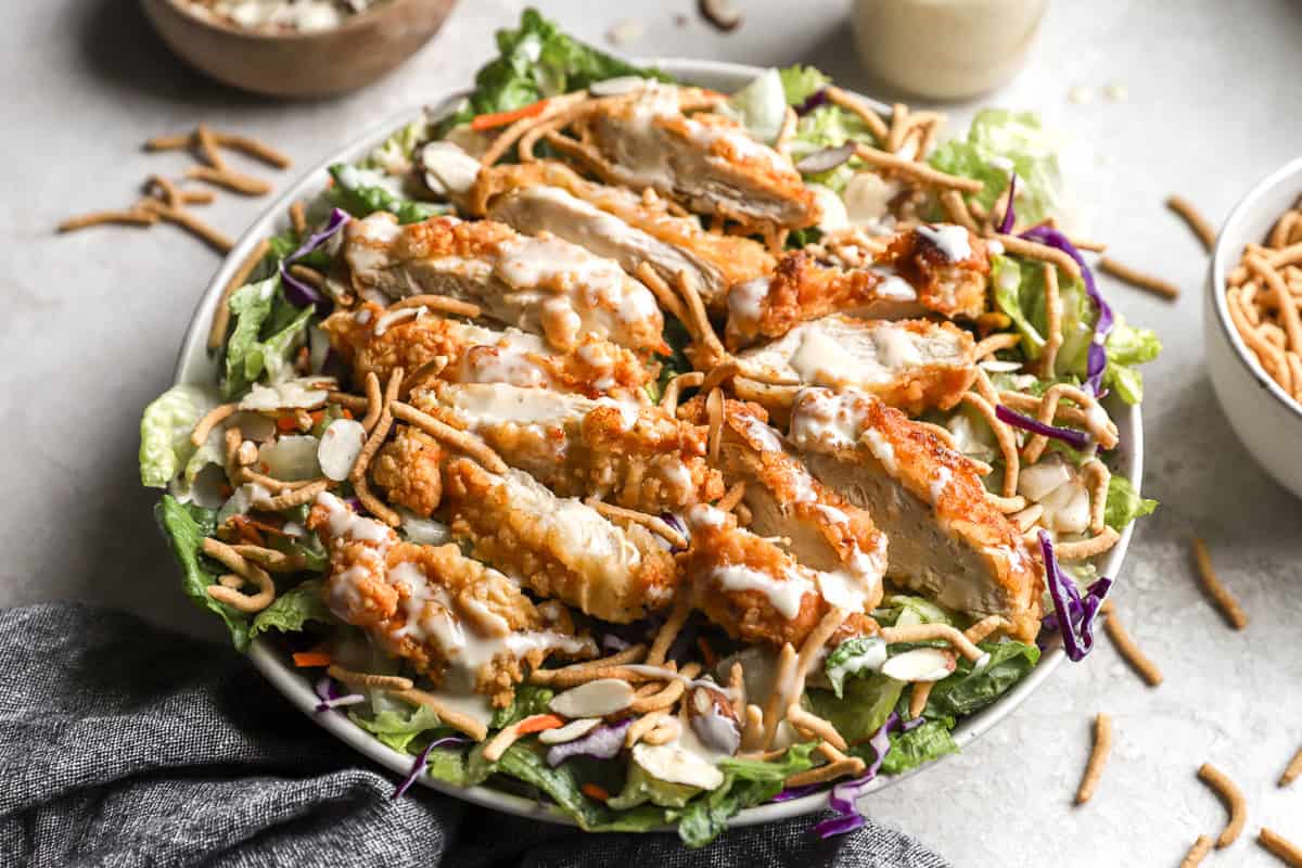 Oriental salad topped with crispy chicken and dressing.