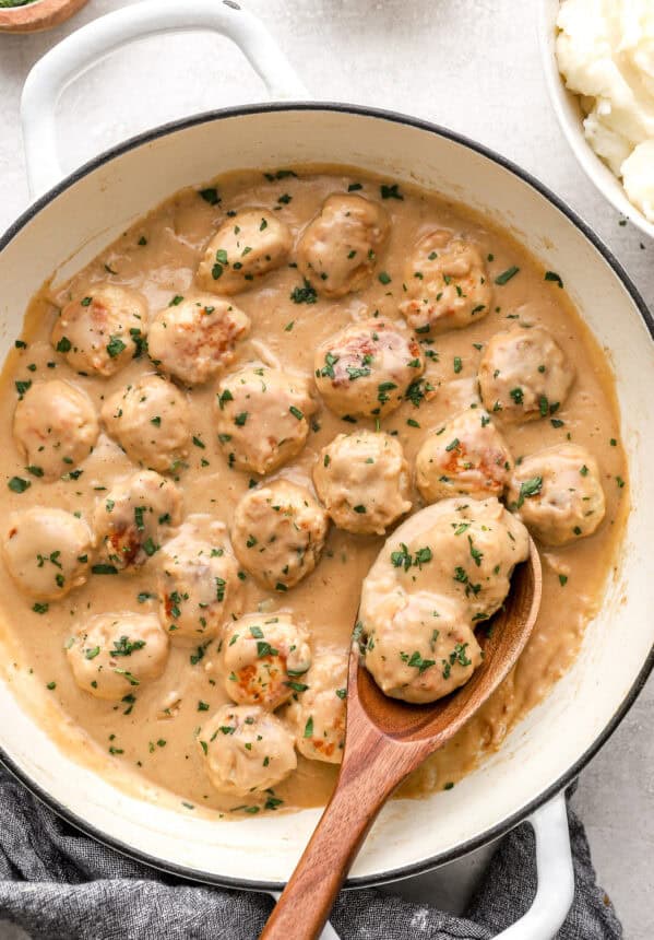 Swedish chicken meatballs in sauce in a large pot.