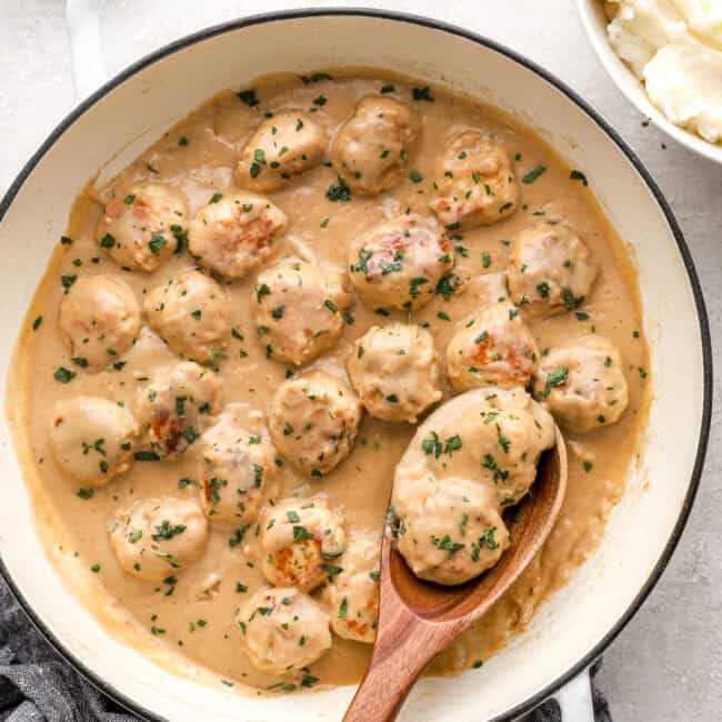 Swedish chicken meatballs in sauce in a large pot.