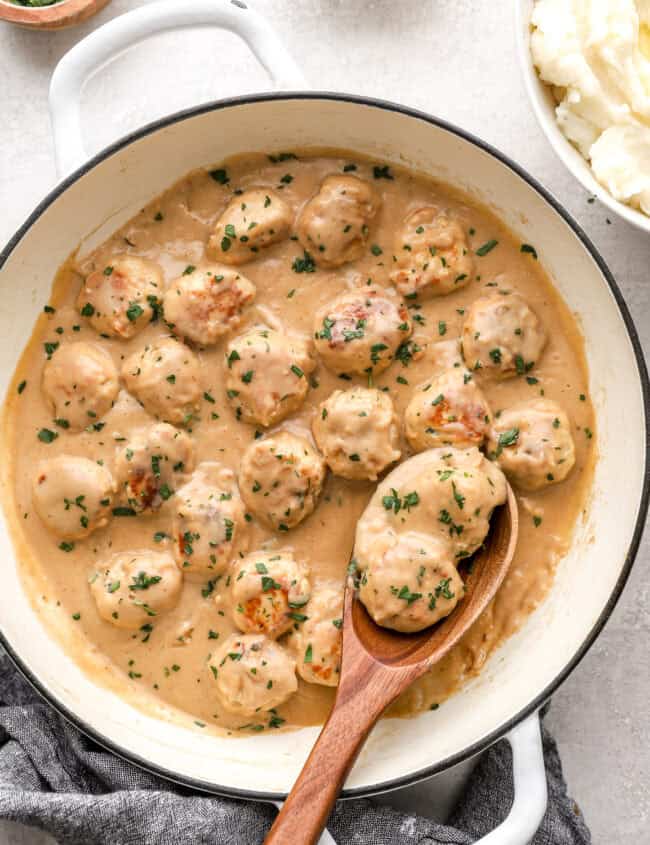 Swedish chicken meatballs in sauce in a large pot.