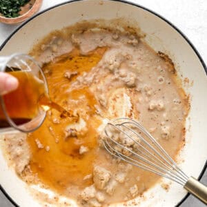 Pouring ingredients into a pot to make a sauce.