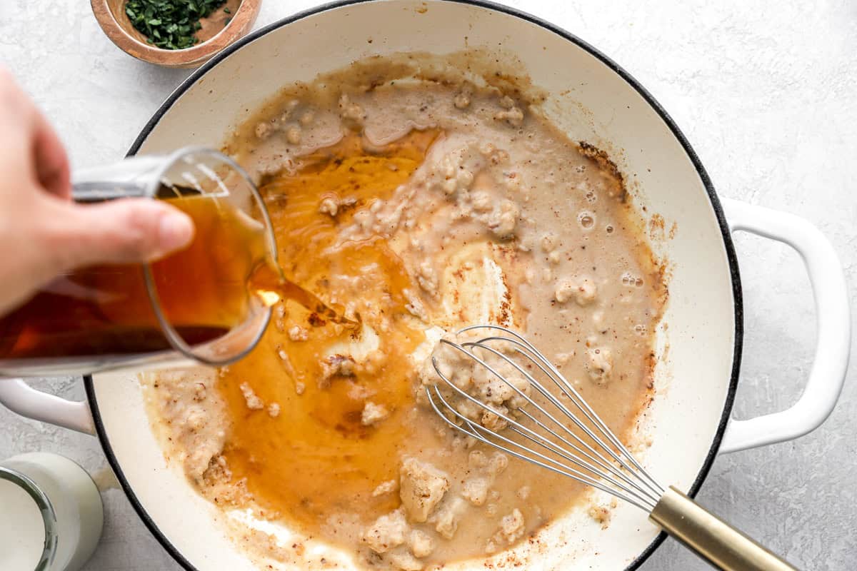 Pouring broth into a pot to make a sauce.