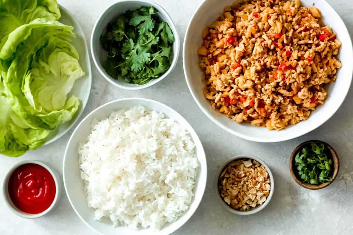 a bowl of chicken lettuce wraps with sauce.