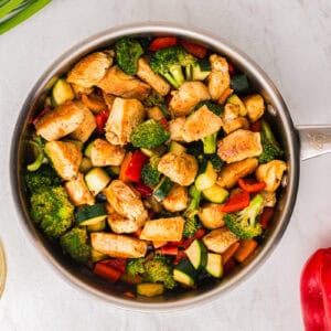 honey soy chicken stir fry in a pan.