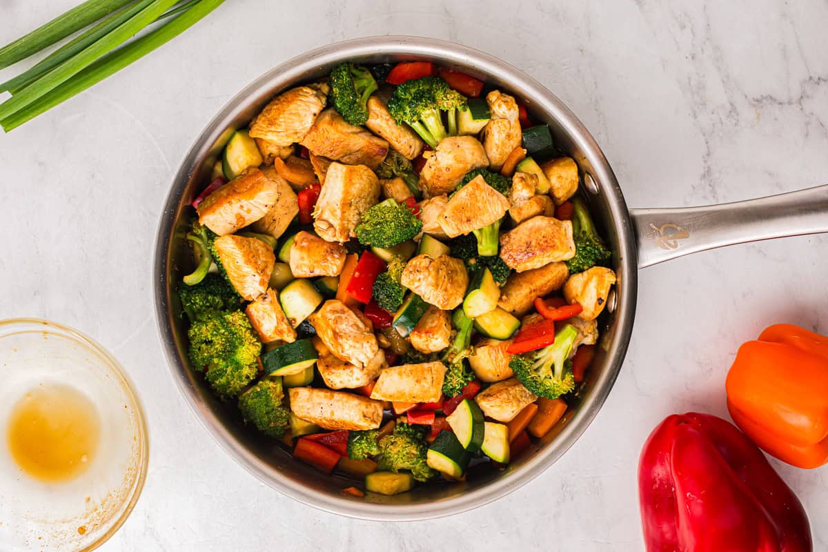 honey soy chicken stir fry in a pan.
