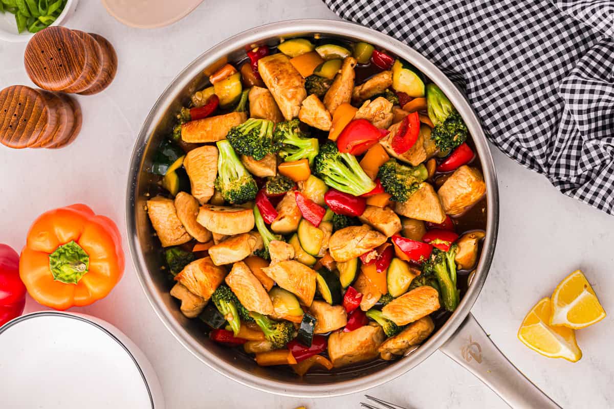 honey soy chicken stir fry in a pan.