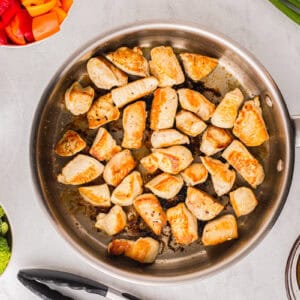 cooked chicken pieces in a pan.