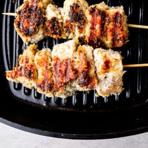 Chicken spiedini skewers cooking on a grill pan.