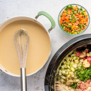 Creamy roux in a saucepan, next to a Crockpot filled with diced veggies and other ingredients.