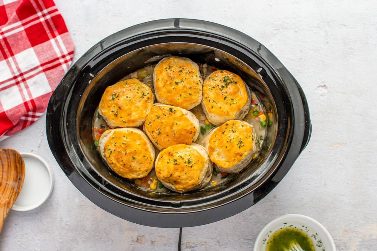 chicken pot pie topped with baked biscuits, in a Crockpot.