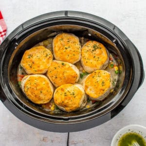 chicken pot pie topped with baked biscuits, in a Crockpot.