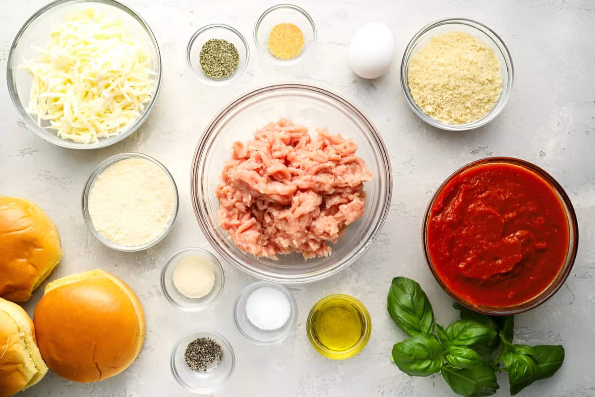 portioned ingredients for chicken parm burgers in individual bowls.