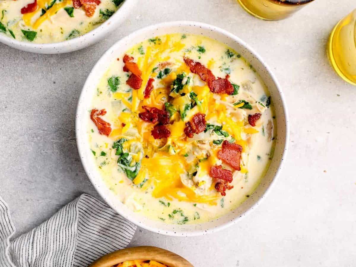 crack chicken soup in a white bowl