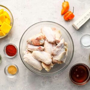 portioned ingredients for mango habanero wings in individual bowls.