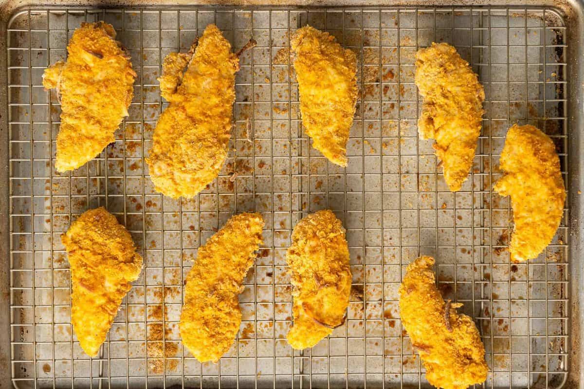 baked chicken strips on baking sheet