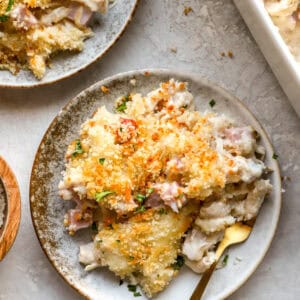 overhead view of a serving of chicken cordon bleu casserole on a plate with a fork.