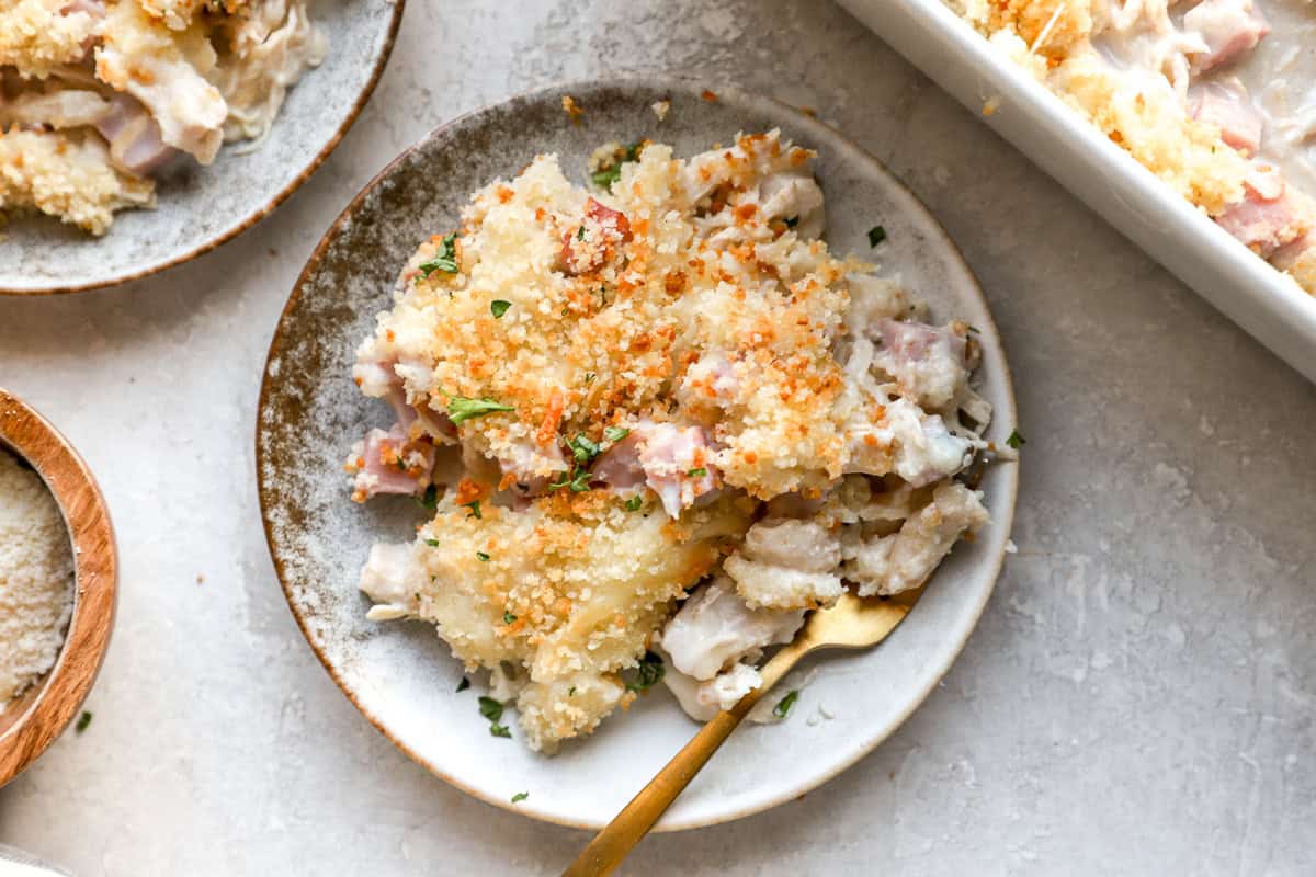 overhead view of a serving of chicken cordon bleu casserole on a plate with a fork.