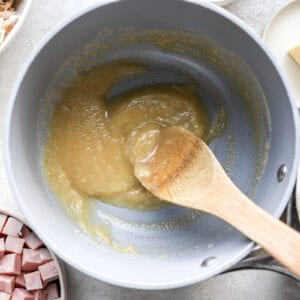 a roux in a pot with a wooden spoon.
