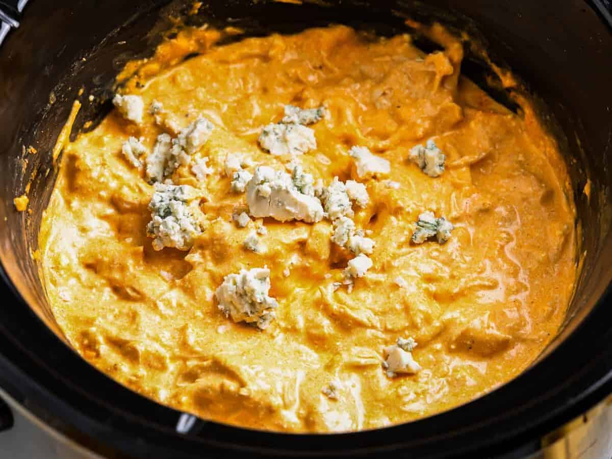 buffalo chicken dip in a crockpot with blue cheese.