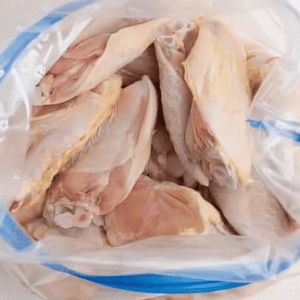 Raw chicken wings in a resealable bag.