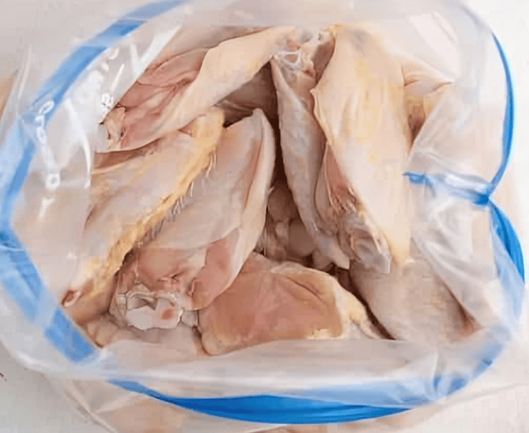 Raw chicken wings in a resealable bag.