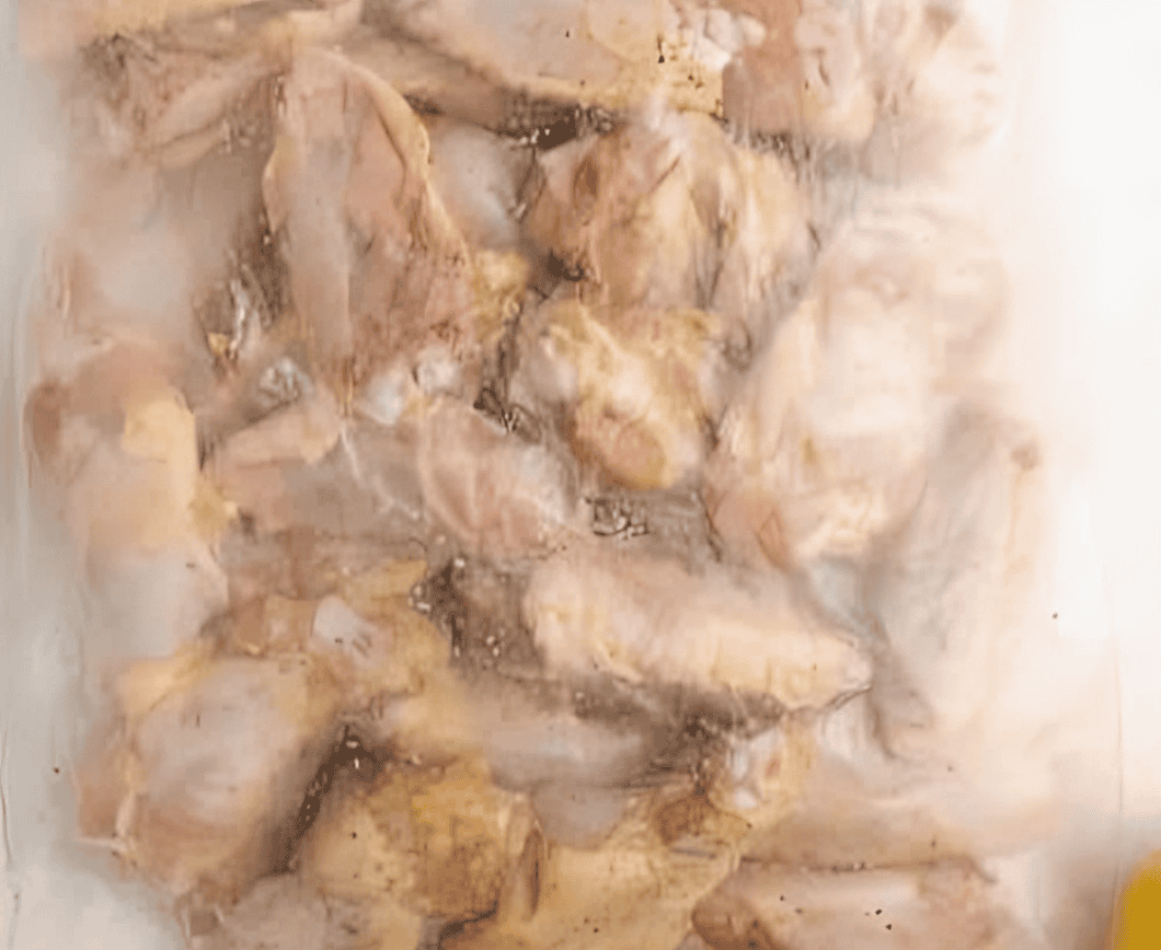 Chicken wings marinating in a bag.