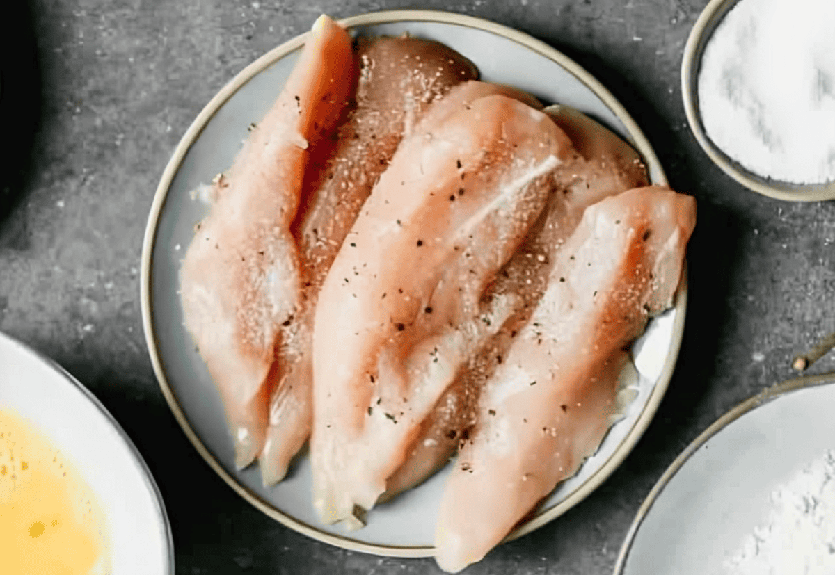 Raw seasoned chicken tenders.