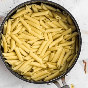 Penne pasta cooking in a pot.