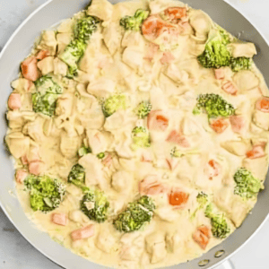 Veggies cooking in a creamy sauce.