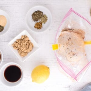 Chicken thighs in a bag, next dishes filled with spices.